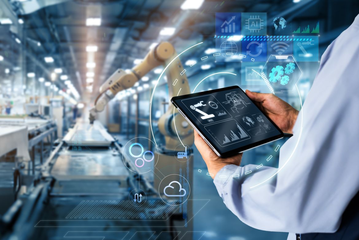 Smart industry control concept.Hands holding tablet on blurred automation machine as background